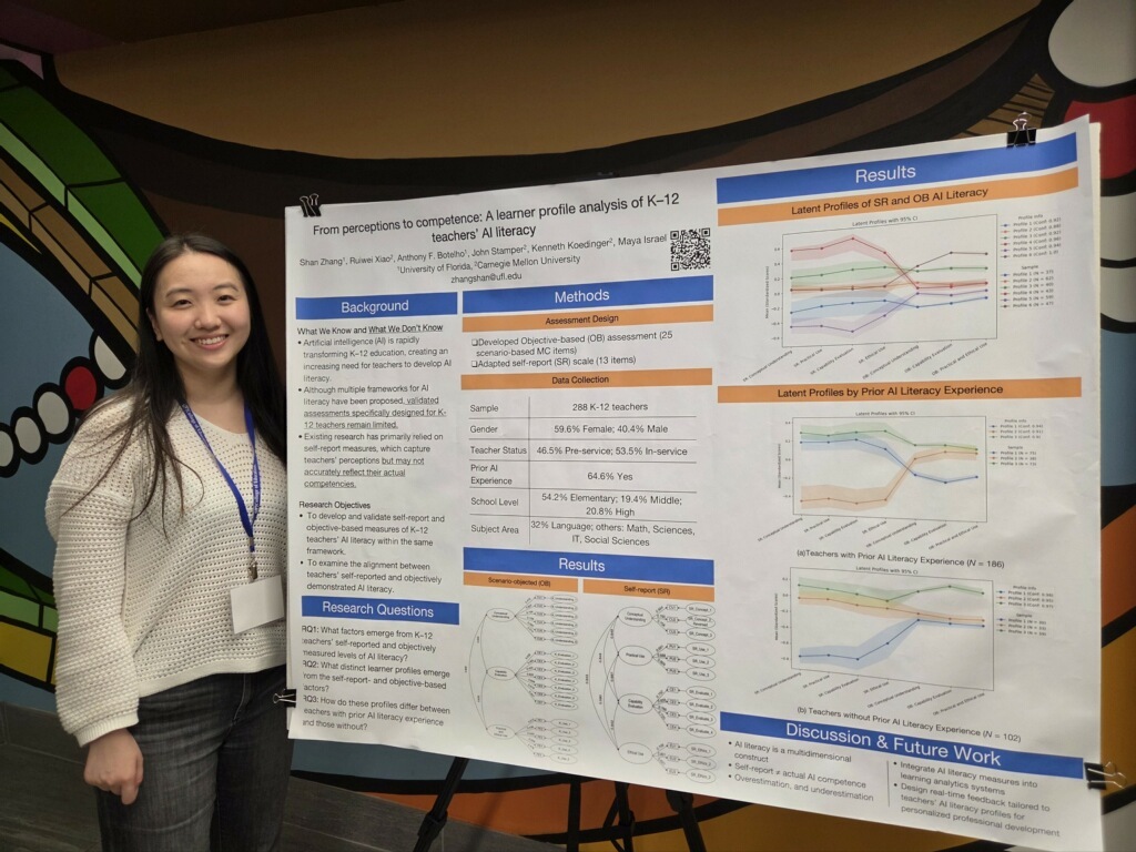Shan Zhang standing and smiling next to her poster presented for AI Literacy Day.